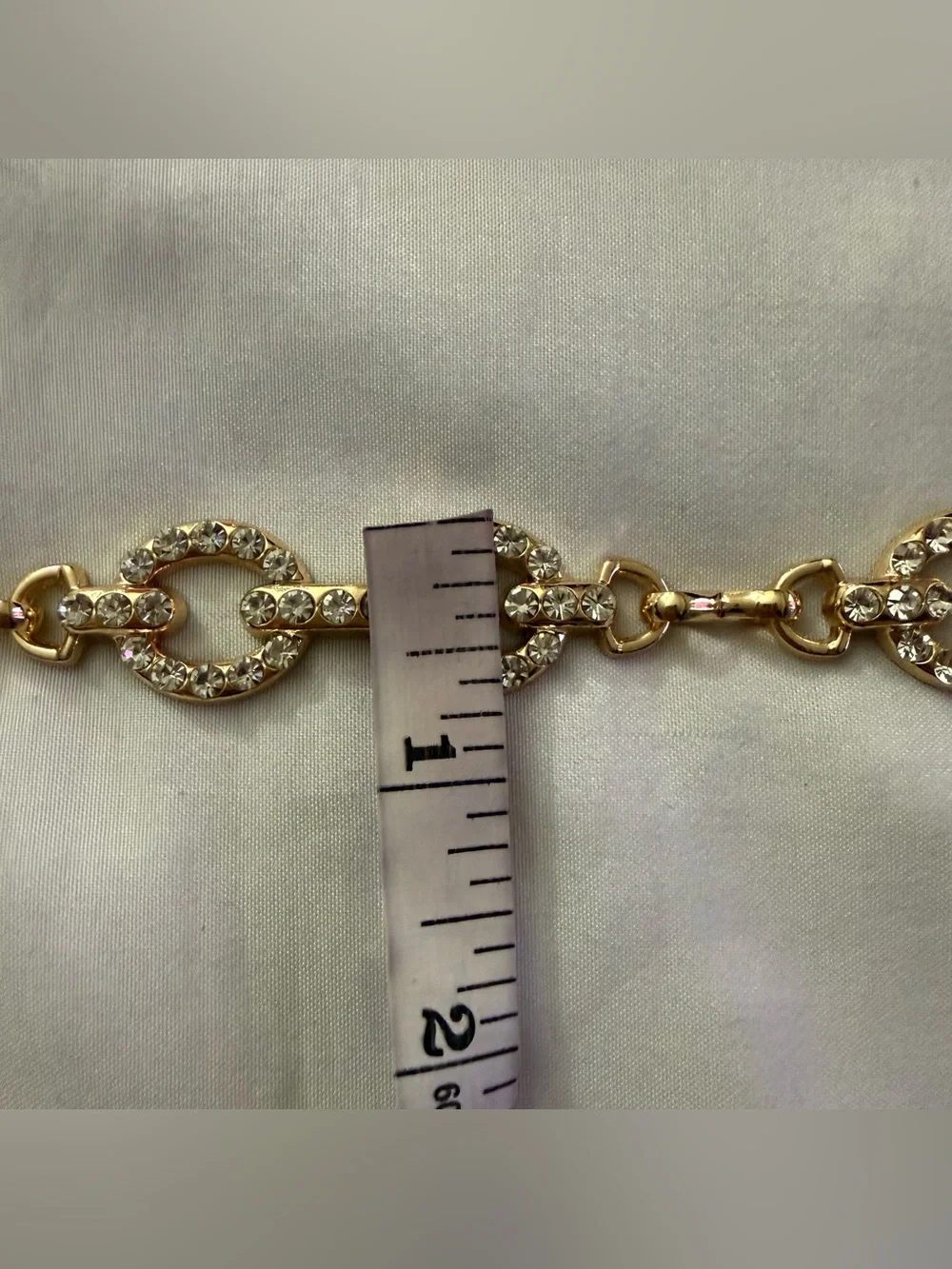 Gold tone oval links metal chain belt with rhinestone details